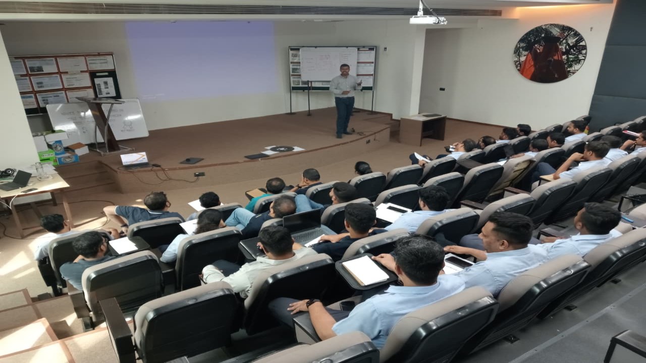 Large corporate ISO training seminar with trainer presenting to professionals